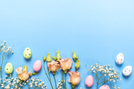 Easter card. Pastel decorative color eggs, delicate flowers of white Gypsophila and peach Eustoma on...