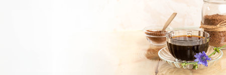 Healthy chicory tea in cup on saucer, granular chicory in bowl and jar, lilac flower on white. Copy space. Chicory tea is prebiotic, good for sleep. Banner illustrated herbal medicine for wellbeing.の写真素材