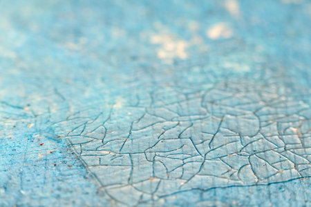 Close-up view of a textured blue surface featuring intricate cracks and patterns, highlighting the artistic details and depth of the material, creating a visually engaging compositionの写真素材