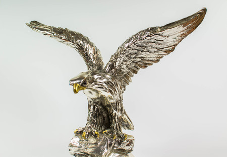 silver statue of an eagle on a white backgroundの写真素材