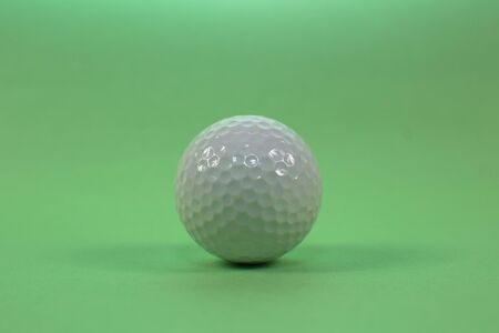 golf ball on a green backgroundの写真素材