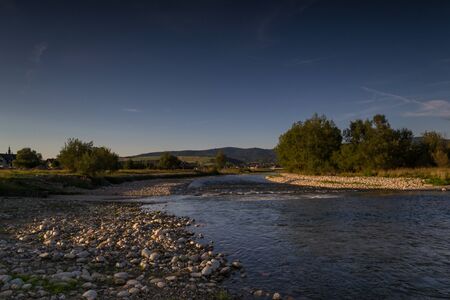 View of the Czarny Dunajec river and distant mountains.
