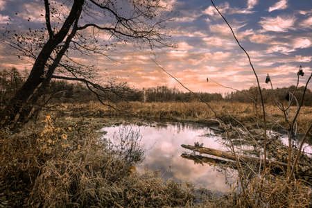 Sunset over a small river in late fall.