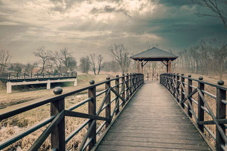 Wooden bridge with a covered gazebo.の写真素材