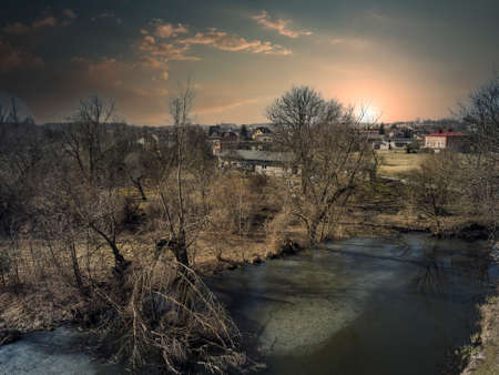 A winding river seen from above in the rays of the setting sun.
