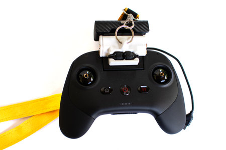 Black drone remote control with yellow strap isolated on a white background.