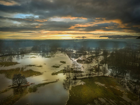 Aerial view of a forest lake at sunset with clouds in the skyの写真素材