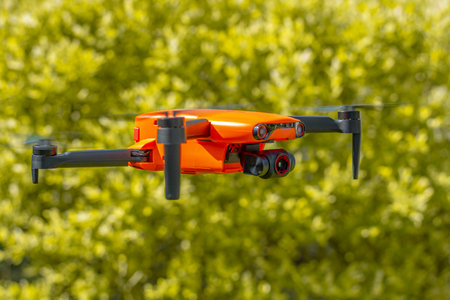 Close up of a drone quadcopter with digital camera flying in the air