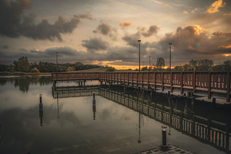 Wooden bridge over the river in the evening with cloudy sky.の写真素材