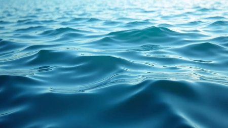 A serene scene of blue ocean water with gentle ripples and reflections under natural sunlight, creating a peaceful and relaxing atmosphere ideal for travel or nature themes.の素材
