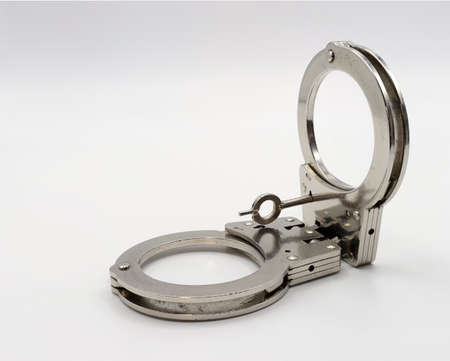 Isolated photo of closed police handcuffs on a clean background