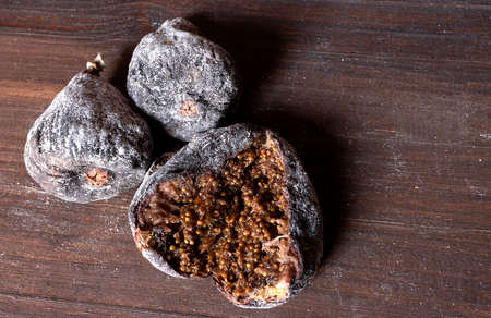 Close up view of three floured dried figs, one of them openの写真素材