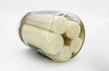 canned palmetto hearts inside a jar on white background