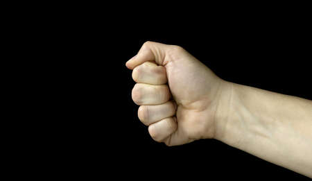 Clenched fist on a black background, Aggressiveness, masculinity, the concept of challenge