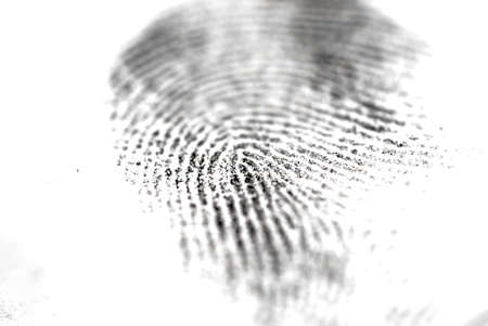 Selective focus of a paper impression of a fingerprint on a white background, concept of criminology and police scienceの写真素材