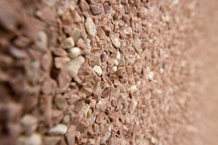 Narrow field in focus on the protective pink coating on a wall in a homeの写真素材