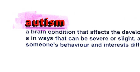 English definition of the word autism, a type of mental disorder, highlighted in red on a white...