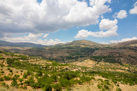 Agricultural field and Hills with cloudy skyの写真素材