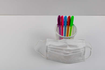 pens in the pen box and a face mask in new normal