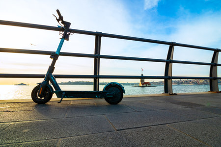 Istanbul Turkey - 12.25.2020: Binbin Electric Scooter in Istanbul. Cityscape of Istanbul with Maiden's Tower on the background.のeditorial素材