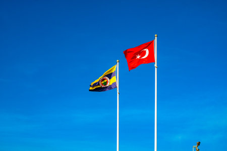 Flags of Fenerbahce SK and Turkey against the blue skyのeditorial素材
