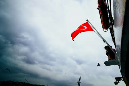 Flag of Turkey on the boat and cloudy sky. Turkish nation. Turkish independence day. 19th may, 23th april, 30th august, 29th octoberの写真素材