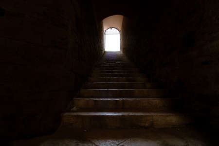 Stairs to the light. End of the tunnel. Afterlife concept. To the heaven concept. Shining light in...