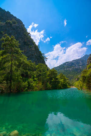 Emerald-colored lake in the forest in a canyon. Goynuk Canyon in Antalya Turkey. Landscape of the lake and forest in a canyon.の写真素材
