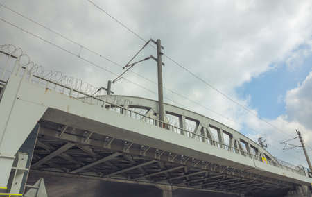 A railroad bridge made with steel and cables and poles on it. transportation background.の写真素材
