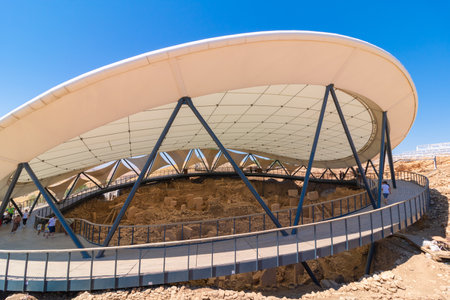 Sanliurfa Turkey - 8.16.2021: Gobeklitepe archaeological site in Sanliurfa. Canopy of the excavation site of Gobeklitepe. Visiting Turkey. Tourism in Turkey.のeditorial素材