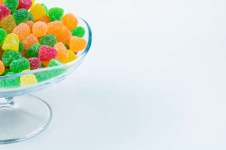 Jelly Candies. Gummy candies in a glass bowl with copy space isolated on white background.の写真素材