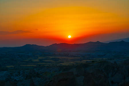 Sunset over the mountains. Sunset scene with silhouettes of mountains. Sundown background photo.の写真素材