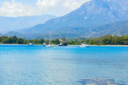 Yachts on the bay. Yachts near the beach in a bay. Vacation background photo. Phaselis Antalya Turkey.の写真素材