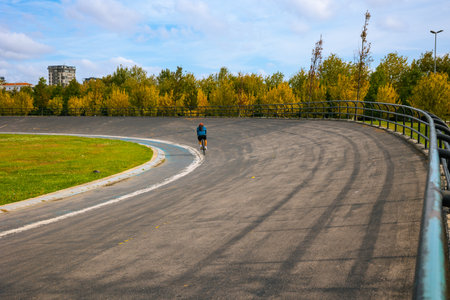 Male Cyclist in Velodrome. Cyclist training in the velodrome in the park. Motion of the biker.の写真素材