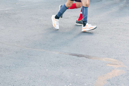 healthy lifestyle background. Motion of the running people on the asphalt. Marathon or exercise or running or healthy lifestyle background with copy space.の写真素材