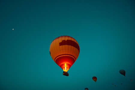 Hot Air Balloon. Fired burner Hot air balloon on the air in Cappadocia. Activities in Cappadocia background photo.の写真素材
