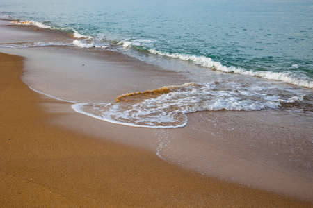 Beach background. Breaking waves on sandy beach.の写真素材