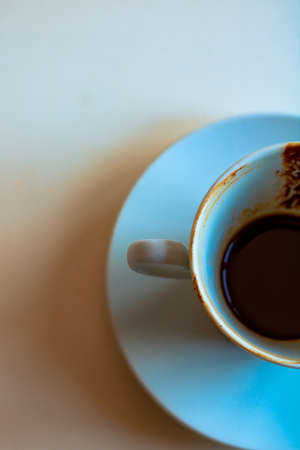 Turkish coffee. Drunk Turkish coffee with grounds in the cup from top view. Half of the cup. Selective focus on foreground.の写真素材