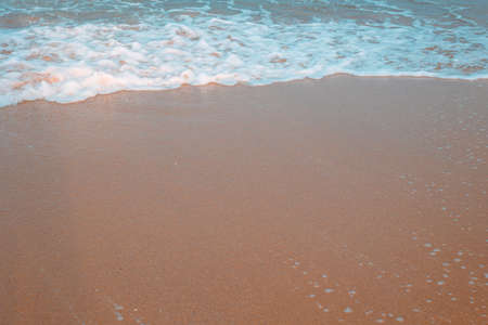 beach photo. Breaking waves with foams on the sandy beach. Travel or vacation or summer background...