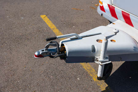 Coupling of a trailer or caravan in focus. Details of the hook or couplings or hitch of a trailer or...