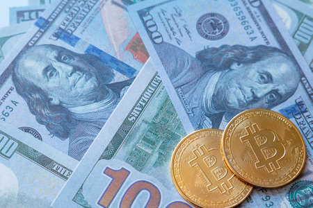 Cryptocurrency and real money concept photo. bitcoins on the us dollars. blockchain or bitcoin or...