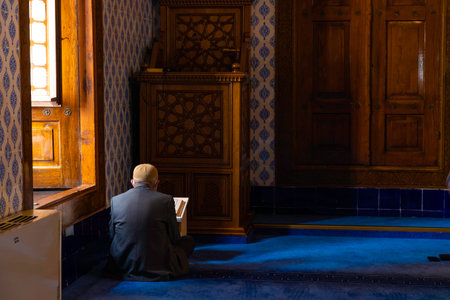 Islamic photo. An elder muslim man reading the Holy Quran in the mosqueのeditorial素材