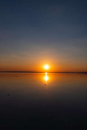 Sunset or sunrise over the lake. Hope or heaven or new life or quote concept vertical or story photo.の写真素材