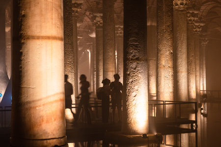 Tourists in Basilica Cistern. Travel to Istanbul background photo. Noise and grain included....