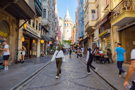 Travel to Istanbul. Galata Tower and tourists on the street. Istanbul Turkey - 8.20.2022のeditorial素材