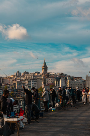 Fishermen and people on the Galata Bridge and Galata Tower on background. Travel to Istanbul vertical background photo. Istanbul Turkey - 5.7.2022のeditorial素材