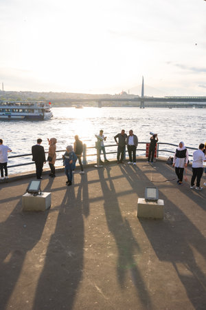 Tourists and local people on the Galata Bridge at sunset. Travel to Istanbul vertical background photo. Istanbul Turkey - 5.7.2022のeditorial素材