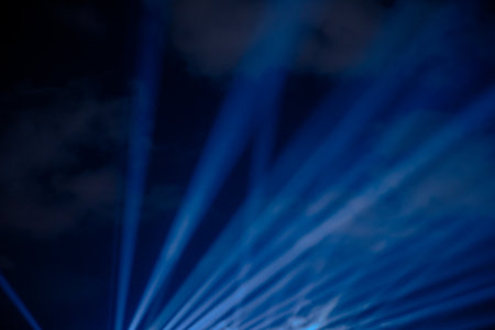 Blue spotlights in outdoor. Spotlight rays background. Night event concept photo.の写真素材
