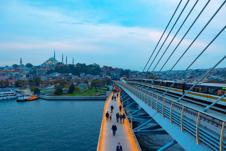 Golden Horn or Halic Metro Bridge. People on the bridge and Suleymaniye Mosque on the background. Istanbul Turkiye - 10.15.2021のeditorial素材