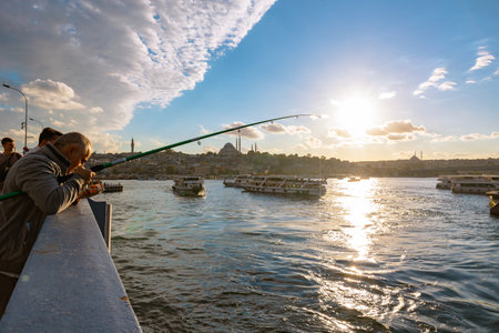 Istanbul skyline from Galata Bridge at sunset. Suleymaniye Mosque and Golden Horn view. Istanbul Turkiye - 10.4.2022のeditorial素材